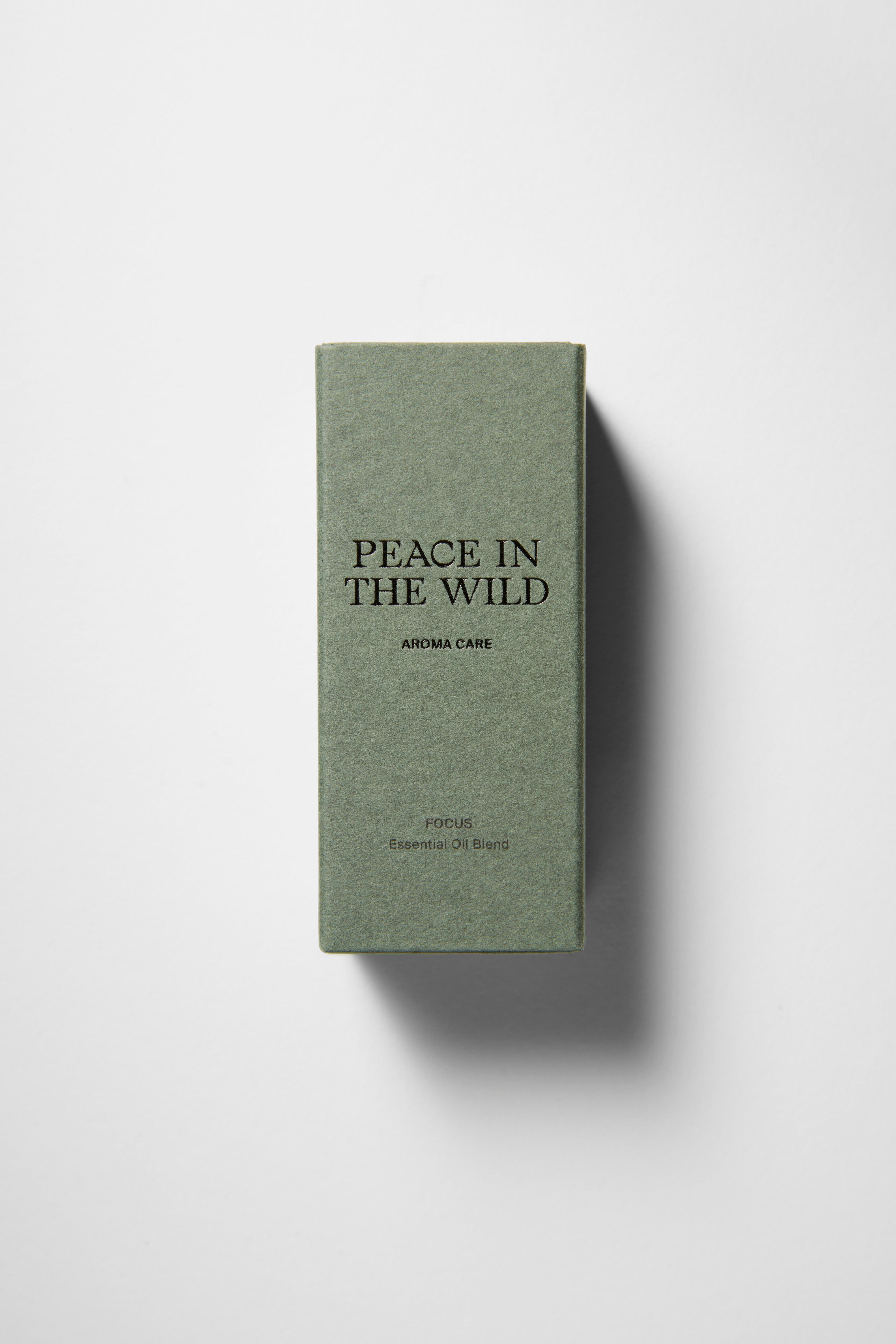 Green paper box with PEACE IN THE WILD - FOCUS Essential Oil Blend 