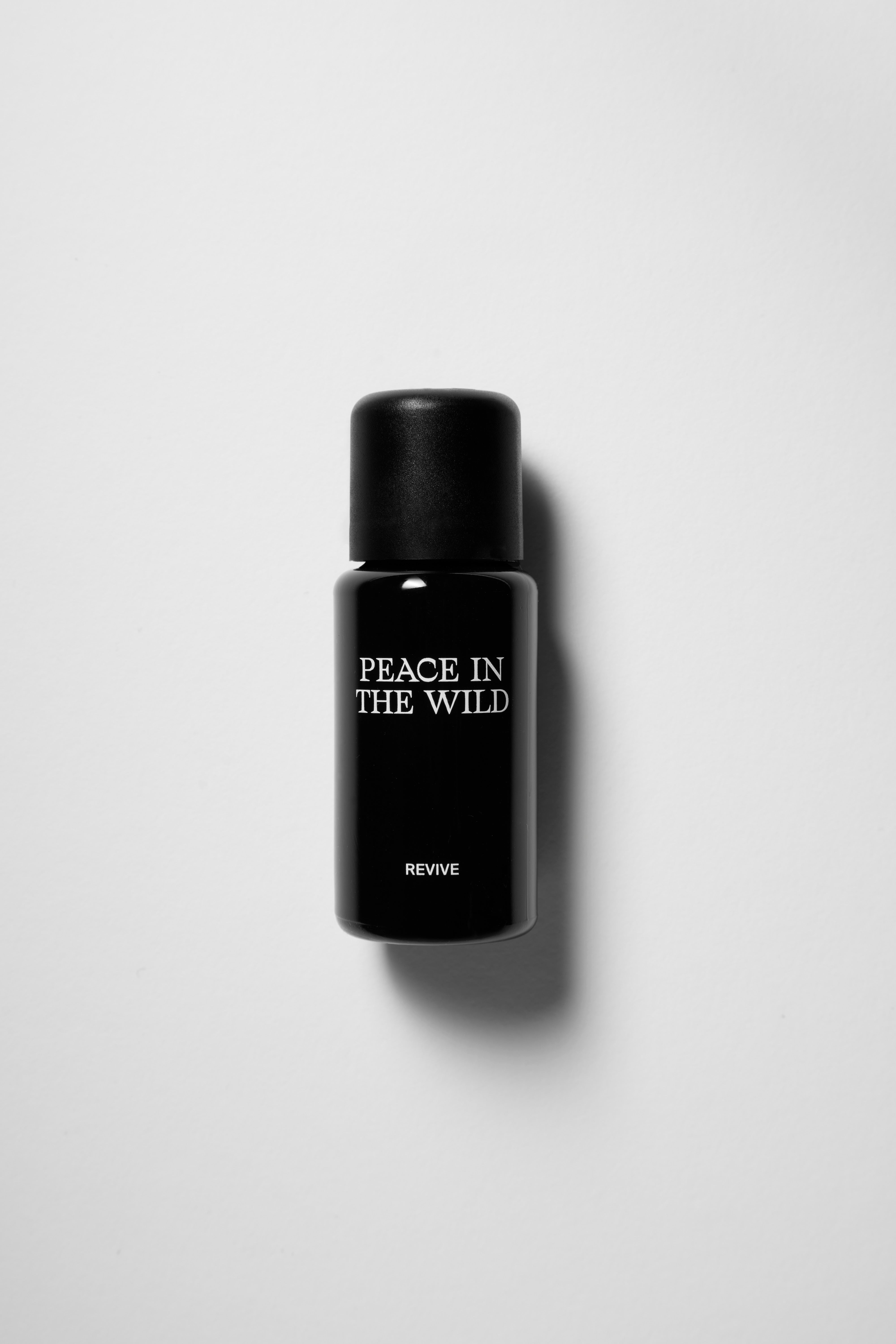15ml black glass bottle of PEACE IN THE WILD Essential Oil Blend REVIVE