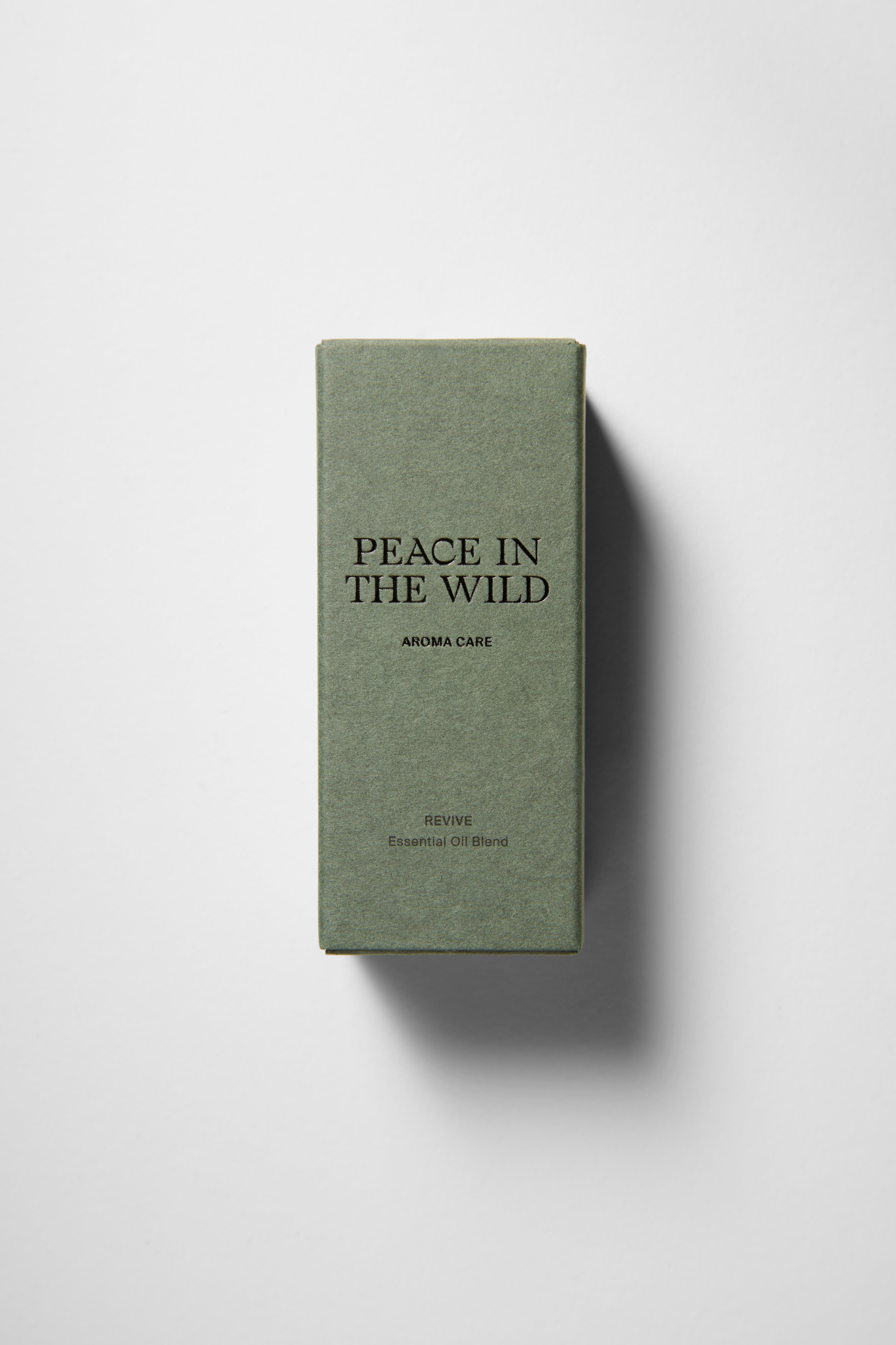 Green paper box with PEACE IN THE WILD - REVIVE Essential Oil Blend 